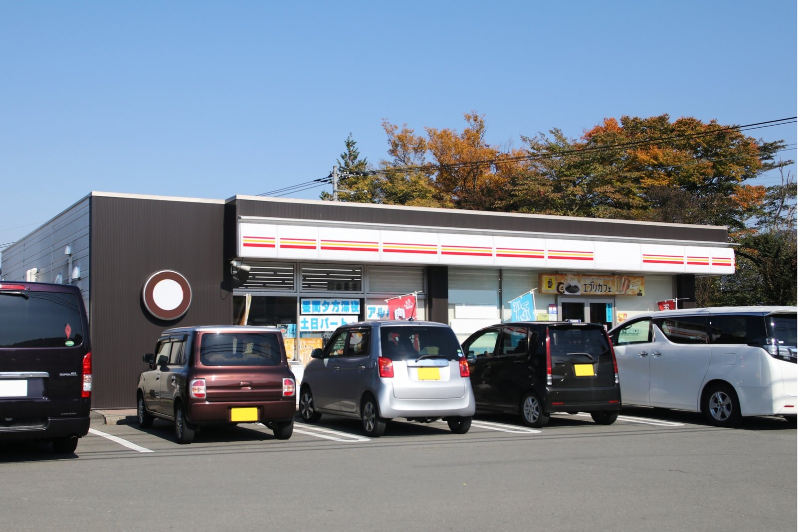 Kei cars parked in front of a convenience store in Nagasaki, reflecting everyday local life