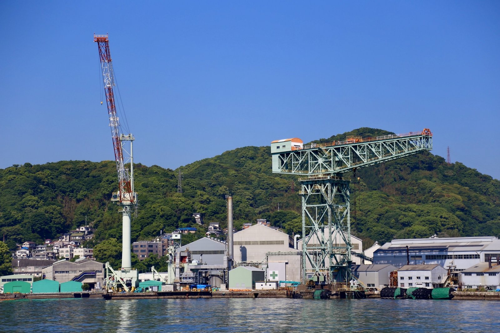 Shipbuilding cranes along Nagasaki Harbor, symbolizing the city’s long history of maritime industry