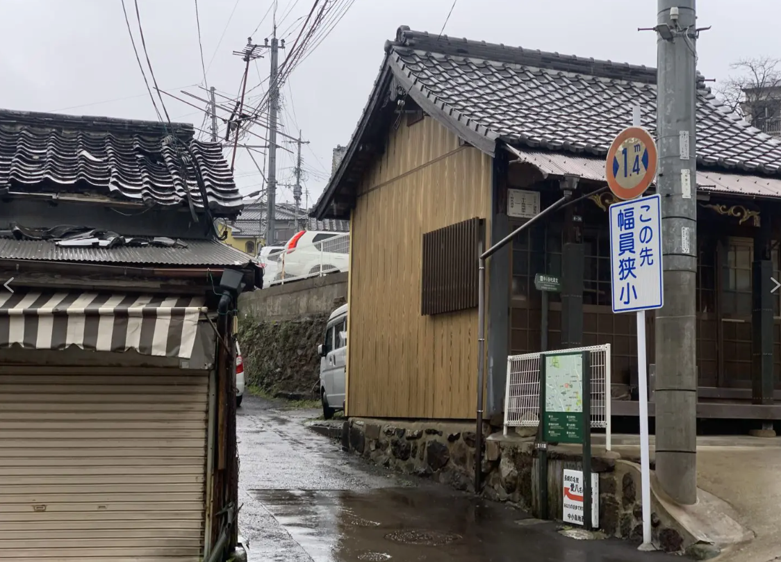 A narrow hillside street in Nagasaki, showing the city’s steep terrain and compact residential roads