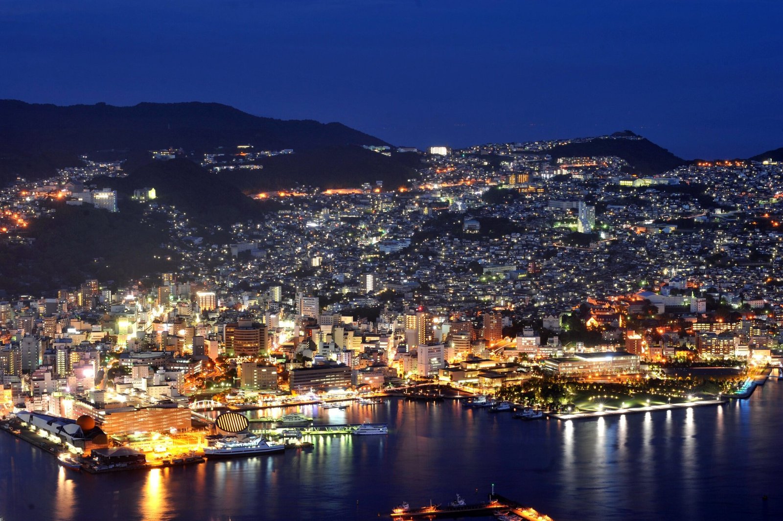 Panoramic night view of Nagasaki from Mount Inasayama, with city lights sparkling across the harbor 