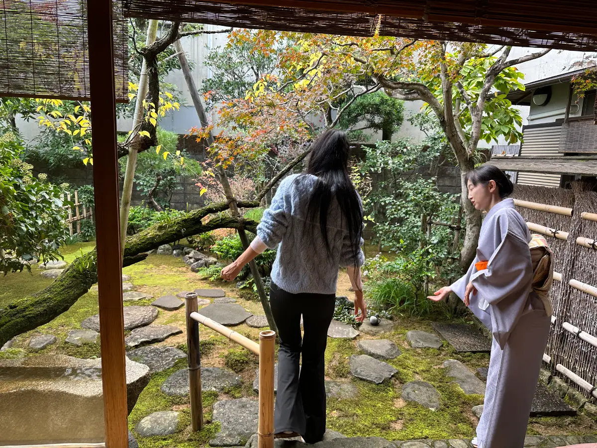 Woman receiving an introduction in a traditional tea garden during a Japanese tea ceremony experienc